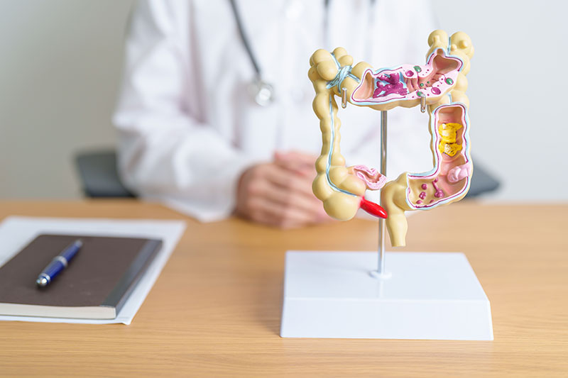 A doctor specialising in colorectal cancer surgery sitting at his table